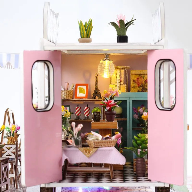 a doll house with a table and chairs inside of it