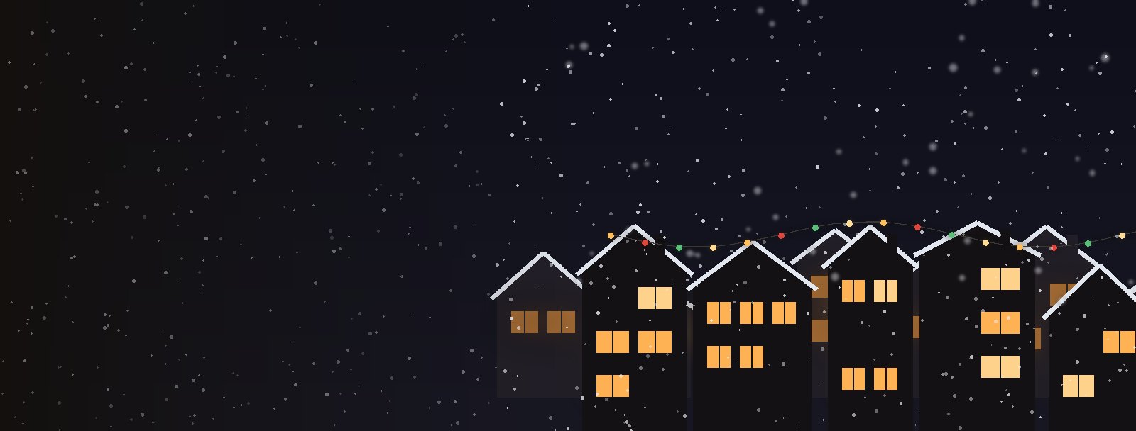 Snow falling over a row of lit miniature houses at night